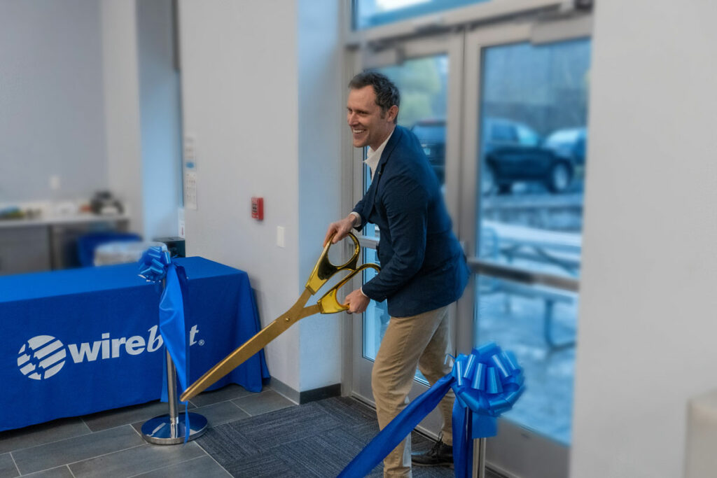Jon Greer, President of Wire Belt Company of America, officially opens Wire Belt’s new facility in Bedford, NH.